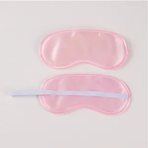 Pink satin sleep mask detail view, soft breathable eye shade for travel and night rest.