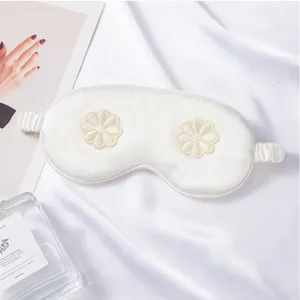 Silk sleeping eye mask with 3D flower embroidery, soft and breathable for travel and home use.