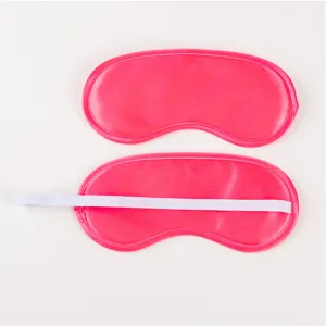 Detailed view of pink satin sleep mask showing soft fabric texture and elastic back strap.