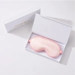Pink silk eye mask detail view, soft satin sleep mask in elegant white gift box presentation.