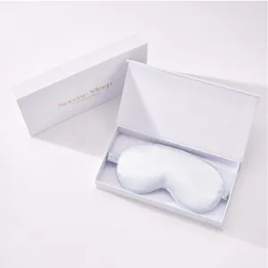 Exquisite detail view of light blue silk eye mask in premium white gift box packaging.