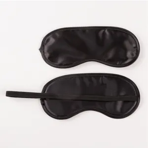 Detailed view of smooth black satin sleep mask with elastic strap for comfort and light blocking.