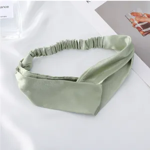 Detailed view of the sage green satin twist headband, comfortable elastic back for daily wear.