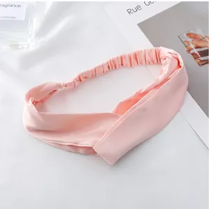 Pink satin twist headband detail, soft elastic hair accessory for daily wear and elegant styles.