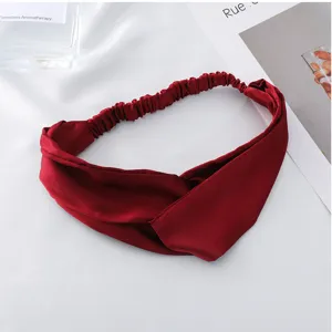 Satin cross headband solid color elastic hair accessory, fine detail close up display.