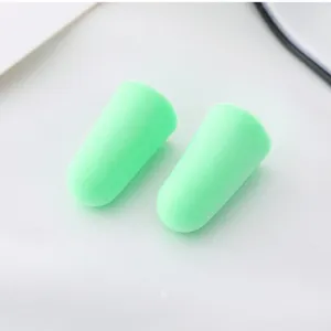 Close-up detail view of soft green slow rebound foam earplugs for noise reduction and sleep.
