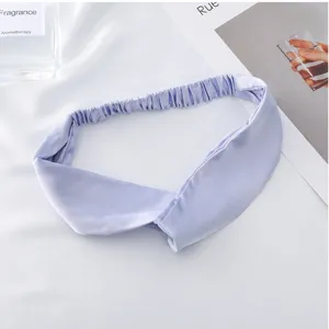 Detail view of smooth lavender satin crossover headband with elastic band for comfortable wear.