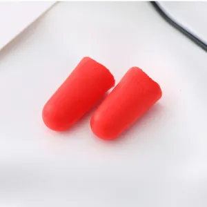Detail shot of soft red foam earplugs designed for noise reduction and peaceful sleep.