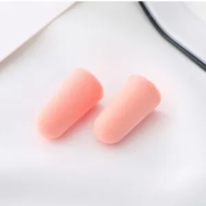 Detail view of pink slow rebound foam earplugs, soft noise reduction for sleeping.