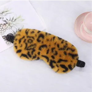 Close-up detail view of the soft plush leopard print sleep mask texture and elastic strap design.