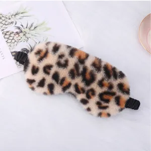 Leopard print plush sleep mask detail, soft fluffy eye cover for comfortable sleeping and resting.