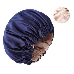 Double layer satin sleep cap for women, soft night hair bonnet in navy blue with pink lining.