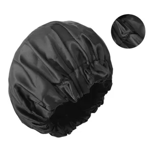 Silk sleeping cap detail showing soft fabric texture, black double-layer night hair care bonnet.