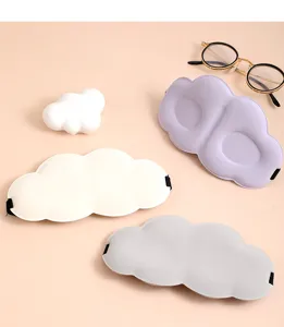 Detail view of 3D cloud shaped memory foam sleeping eye mask in assorted pastel colors.