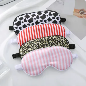 Soft silk sleep eye mask with cute cow, leopard and stripe prints for comfortable resting.