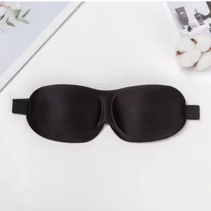 Detail of black 3D contoured sleep mask featuring soft fabric and flexible elastic strap.