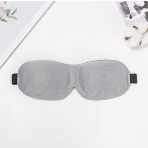 Grey 3D contoured sleep mask for travel and restful night sleep with comfortable elastic strap.