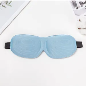 Light blue 3D contoured sleep mask detail, ergonomic eye socket design for total blackout.