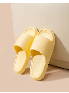 Close-up of yellow EVA home slippers, soft texture and anti-slip sole design for indoor comfort.