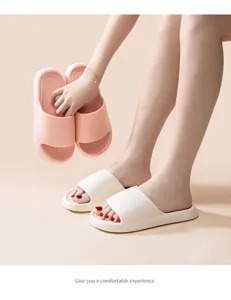 Detailed view of lightweight EVA home slippers in pink and white, comfortable everyday indoor footwear.