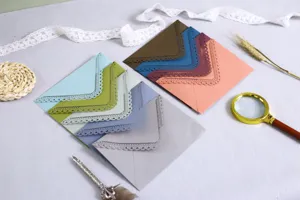 Close-up of colorful laser-cut lace envelopes for wedding invitations and greeting cards.