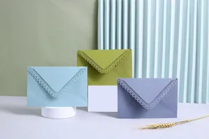 Detail shot of colored laser-cut lace hollow triangular envelopes for weddings and invitations.