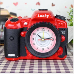 Creative camera shaped alarm clock detail view, red and black plastic design with quartz.
