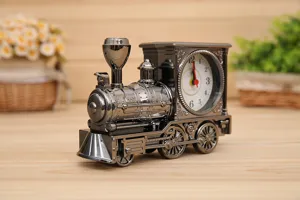 Detailed close-up of a vintage locomotive train alarm clock with metallic finish and dial.