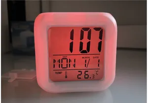 Color changing square digital alarm clock with LED night light and temperature display.