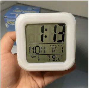 Digital alarm clock detail showing clear LCD screen with time, date and temperature display.