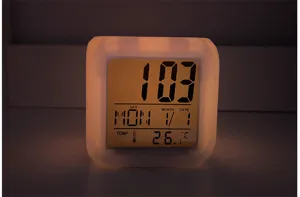LED digital cube alarm clock detail view showing glowing night light and clear temperature.