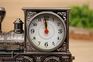 Close-up detail view of vintage locomotive alarm clock dial with classic clock face numbers.