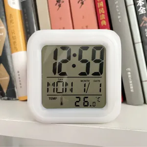 White square digital alarm clock with color changing LED light, time and temperature display.