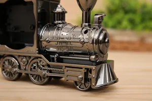 Detailed view of vintage locomotive alarm clock, electroplated silver toy train ornament.