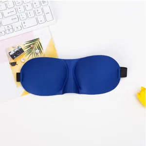 3D contoured sleep mask detail showing molded eye sockets and soft blue fabric material.