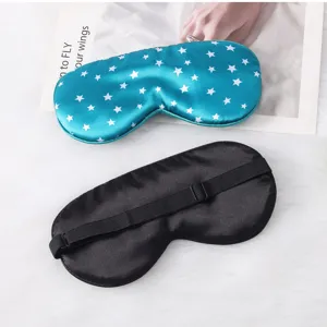 Detail view of smooth silk sleep masks with star print and adjustable black strap for travel.