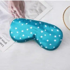 Blue simulated silk sleep mask with white star print, soft shading design for travel.
