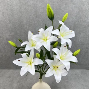 Close-up of artificial white lily flower arrangement with green buds in an elegant vase.