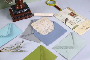 Colored hollow triangular envelopes with laser carved lace edge for vintage wedding invitations.