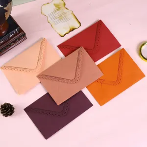 Colorful laser cut lace triangular envelopes for wedding invitations and greeting cards.
