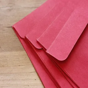 Red kraft paper envelopes, retro plain style stationery, classic western design detail view.