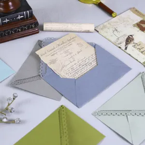Colored hollow triangle envelopes with laser-carved lace for wedding party invitations.