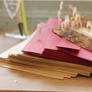 Close-up detail view of stacked vintage kraft paper and red envelopes for daily storage.
