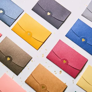 Colorful pearlescent paper envelopes with heart gold stamping closure flat lay view.
