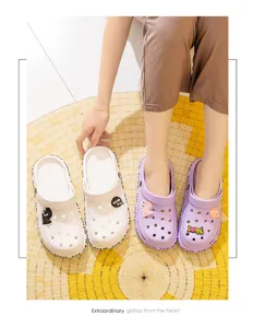 Detail view of couple cartoon hole shoes, cute charms and letters, comfortable beach sandals.