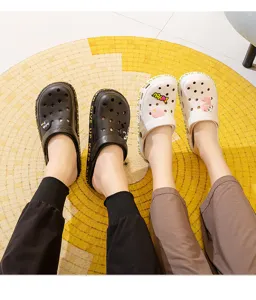 Comfortable couple garden clogs with cute charms and breathable holes for summer beach wear.
