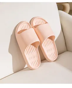 Pink home sliding slippers detail view, comfortable soft sole daily indoor footwear showcase.