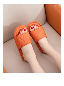 Orange quilted platform slide slippers for women and men, comfortable thick sole casual shoes.