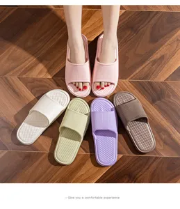 Close-up of colorful EVA home slippers arranged on a wooden floor, comfortable design.