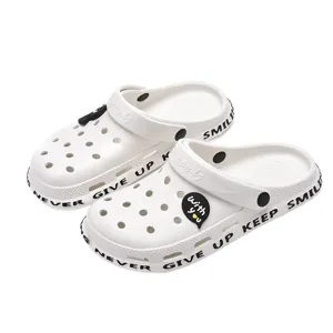 White couple garden clogs with breathable holes and stylish letter print, comfortable beach shoes.